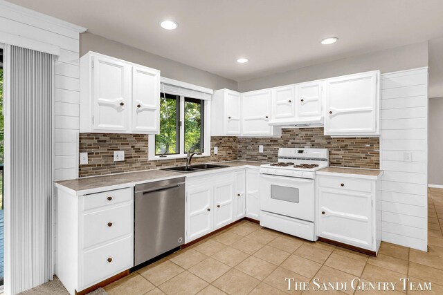 6372 Lake Harbor Rd, Norton Shores, MI 49441 - kitchen featuring stainless steel dishwasher, white gas range oven, a sink, light countertops, and recessed lighting