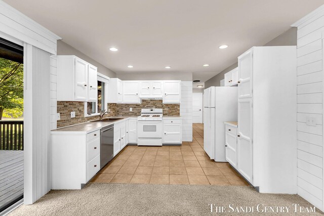 6372 Lake Harbor Rd, Norton Shores, MI 49441 - kitchen featuring white appliances, a sink, backsplash, white cabinetry, and light countertops