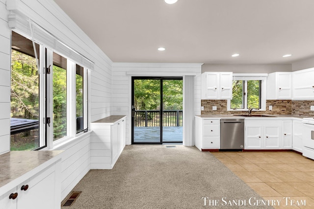 6372 Lake Harbor Rd, Norton Shores, MI 49441 - kitchen with dishwasher, a sink, plenty of natural light, decorative backsplash, and recessed lighting