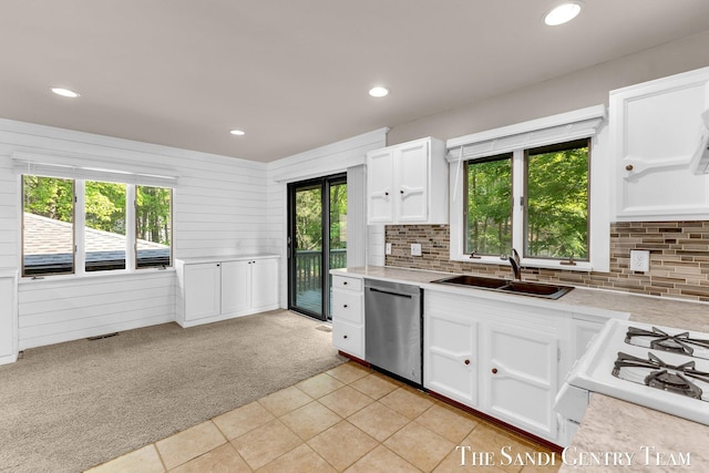 6372 Lake Harbor Rd, Norton Shores, MI 49441 - kitchen featuring dishwasher, a sink, light countertops, white cabinets, and light carpet
