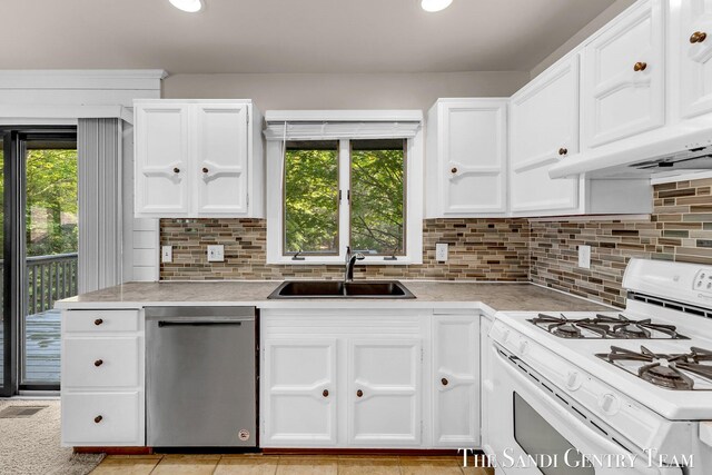 6372 Lake Harbor Rd, Norton Shores, MI 49441 - kitchen with gas range gas stove, dishwasher, a sink, light countertops, and recessed lighting