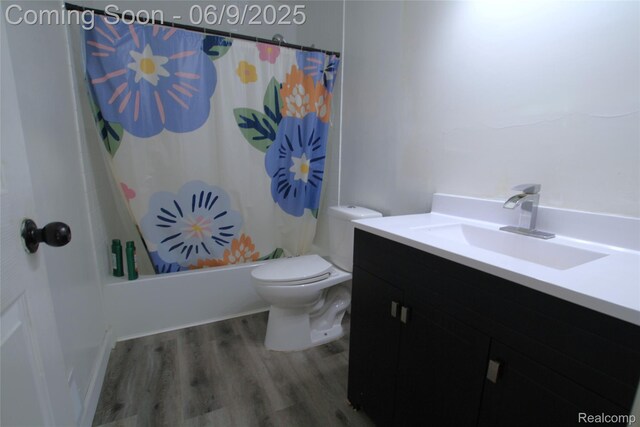 6325 Clarkston Rd, Clarkston, MI 48346 - bathroom with vanity, wood finished floors, toilet, and shower / bathtub combination with curtain