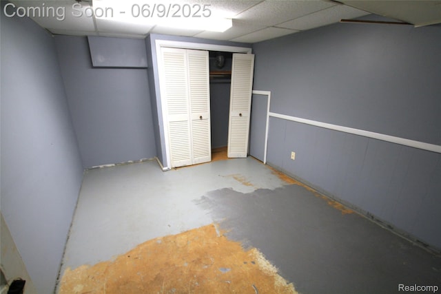 6325 Clarkston Rd, Clarkston, MI 48346 - unfurnished bedroom with concrete flooring, a closet, and a drop ceiling