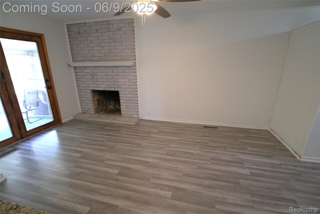 6325 Clarkston Rd, Clarkston, MI 48346 - unfurnished living room with wood finished floors, a ceiling fan, a fireplace, and baseboards