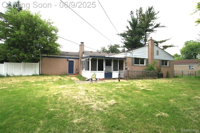 6325 Clarkston Rd, Clarkston, MI 48346 - back of house with brick siding, a sunroom, a chimney, and central air condition unit