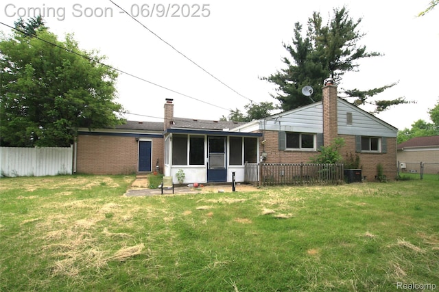 6325 Clarkston Rd, Clarkston, MI 48346 - back of house featuring a chimney, brick siding, a sunroom, and central air condition unit