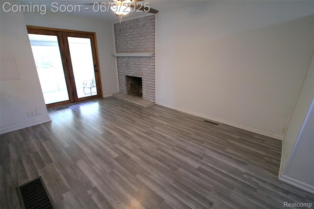 6325 Clarkston Rd, Clarkston, MI 48346 - unfurnished living room featuring wood finished floors, a brick fireplace, baseboards, and ceiling fan