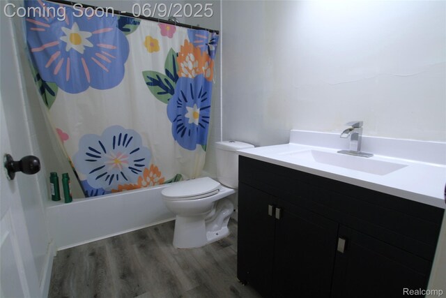 6325 Clarkston Rd, Clarkston, MI 48346 - bathroom featuring vanity, wood finished floors, toilet, and shower / bathtub combination with curtain