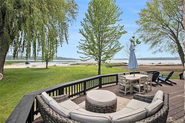 8721 Bayview Rd, Onekama, MI 49675 - deck featuring a water view, a lawn, and outdoor dining area