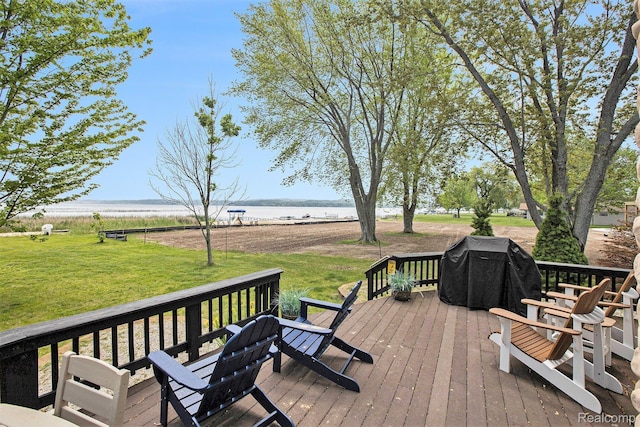 8721 Bayview Rd, Onekama, MI 49675 - wooden deck featuring a water view, a grill, and a yard