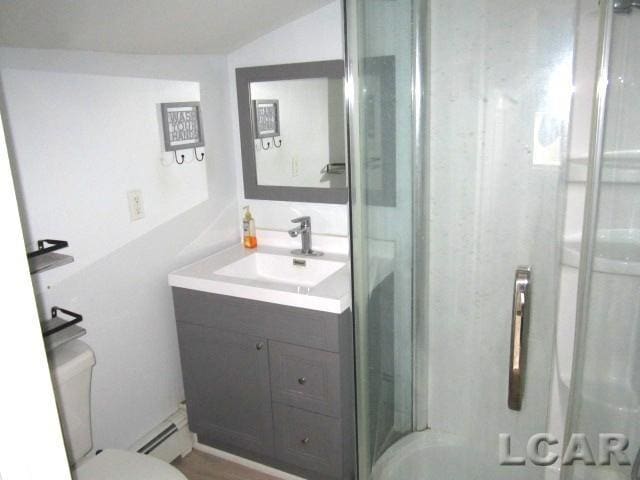 311 Tiffin St, Hudson, MI 49247 - bathroom with vanity, a baseboard heating unit, toilet, a shower stall, and lofted ceiling