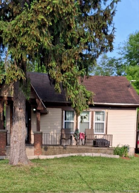 15859 Braile St, Detroit, MI 48223 - rear view of house featuring covered porch, a yard, and a shingled roof