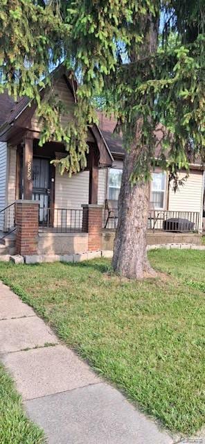15859 Braile St, Detroit, MI 48223 - view of front of home with covered porch and a front yard