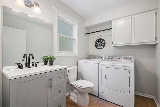 15878 New Holland St, Holland, MI 49424 - bathroom with washing machine and clothes dryer, wood finished floors, and vanity