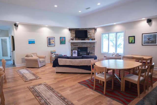 103 Diamond Point Ln, New Buffalo, MI 49117 - dining area with a stone fireplace, recessed lighting, light wood-style floors, and baseboards