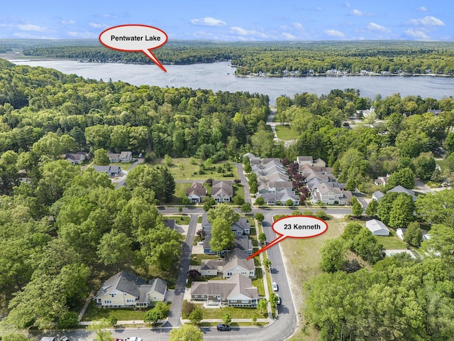 23 Kenneth St, Pentwater, MI 49449 - aerial perspective of suburban area featuring a heavily wooded area and a large body of water