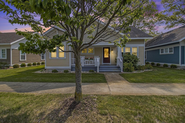 23 Kenneth St, Pentwater, MI 49449 - view of front of home featuring a front yard and a porch
