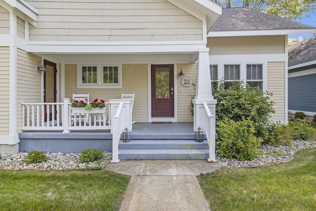 23 Kenneth St, Pentwater, MI 49449 - doorway to property featuring a porch and roof with shingles