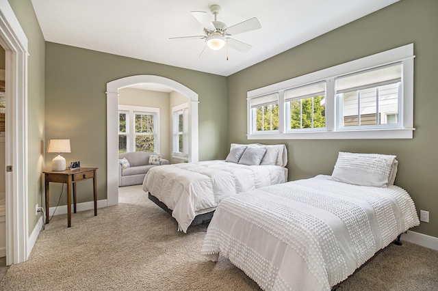 23 Kenneth St, Pentwater, MI 49449 - bedroom with carpet, baseboards, arched walkways, and a ceiling fan