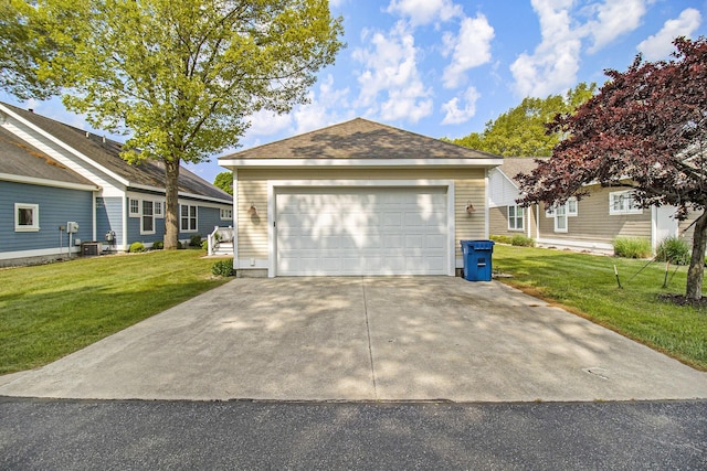 23 Kenneth St, Pentwater, MI 49449 - view of front facade with a front yard, cooling unit, and a detached garage