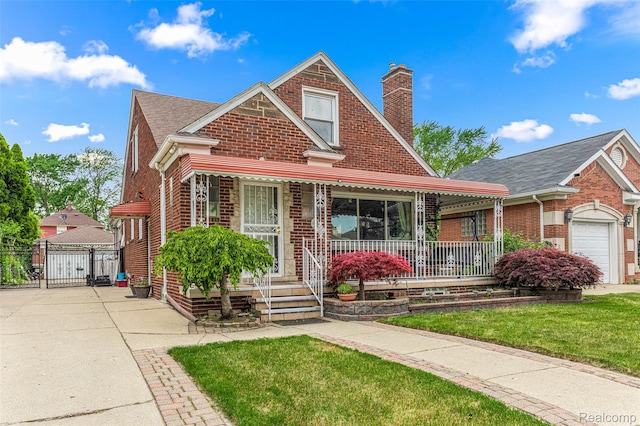 5835 Oakman Blvd, Dearborn, MI 48126 - view of front of house featuring brick siding, a gate, a chimney, and covered porch