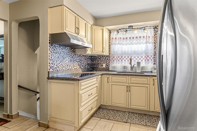 5835 Oakman Blvd, Dearborn, MI 48126 - kitchen featuring cream cabinetry, freestanding refrigerator, a sink, under cabinet range hood, and tasteful backsplash