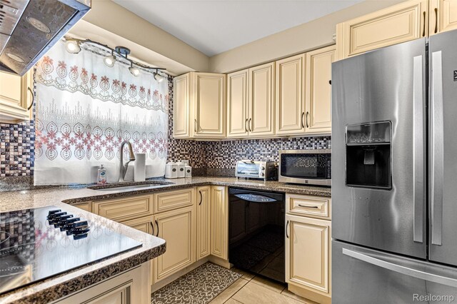 5835 Oakman Blvd, Dearborn, MI 48126 - kitchen with black appliances, cream cabinets, a sink, and range hood