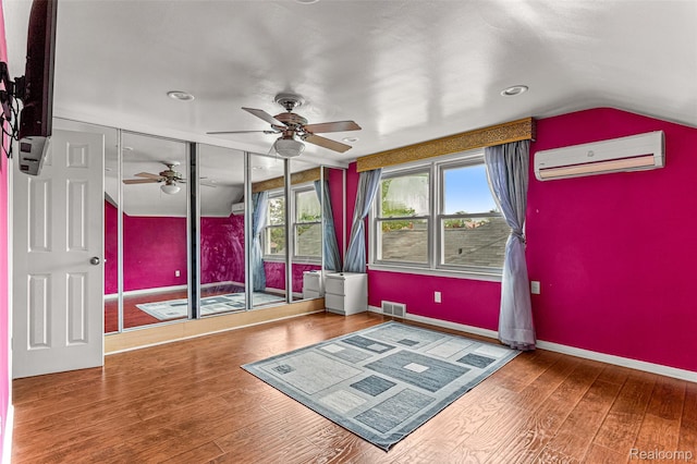 5835 Oakman Blvd, Dearborn, MI 48126 - unfurnished room featuring a wall mounted AC, ceiling fan, vaulted ceiling, hardwood / wood-style floors, and baseboards