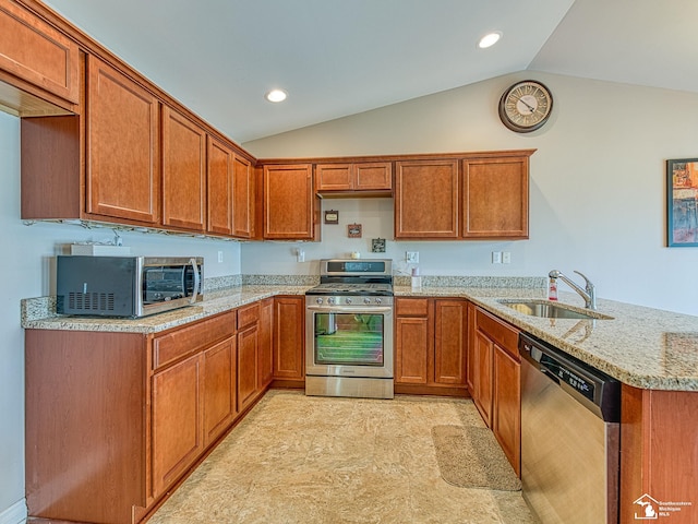8721 E Park Ridge Cir, Newport, MI 48166 - kitchen with appliances with stainless steel finishes, a sink, lofted ceiling, a peninsula, and brown cabinetry