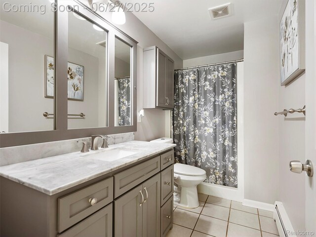 11474 Clairmont Dr, Fenton, MI 48430 - full bath with a baseboard radiator, tile patterned floors, and vanity
