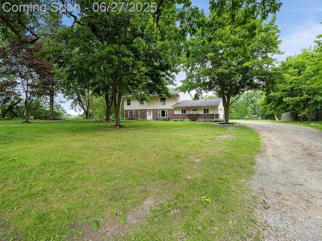 11474 Clairmont Dr, Fenton, MI 48430 - view of front of home featuring driveway and brick siding