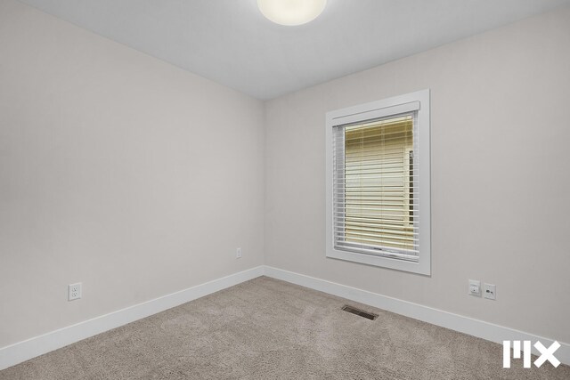 627 Fairview Ave NE Unit 2, Grand Rapids, MI 49503 - unfurnished room with carpet flooring and baseboards