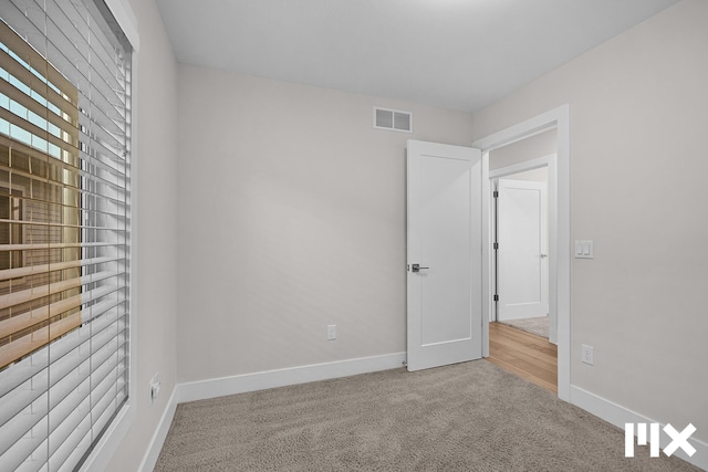 627 Fairview Ave NE Unit 2, Grand Rapids, MI 49503 - unfurnished bedroom with carpet flooring and baseboards