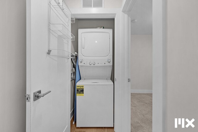 627 Fairview Ave NE Unit 2, Grand Rapids, MI 49503 - laundry room with stacked washer and clothes dryer and baseboards