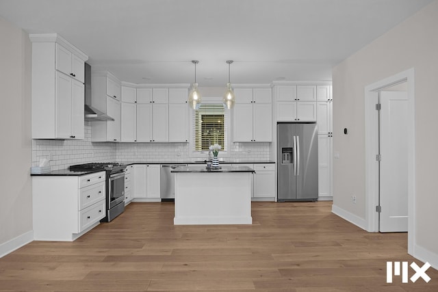 627 Fairview Ave NE Unit 2, Grand Rapids, MI 49503 - kitchen featuring appliances with stainless steel finishes, wall chimney exhaust hood, dark countertops, baseboards, and light wood-style floors