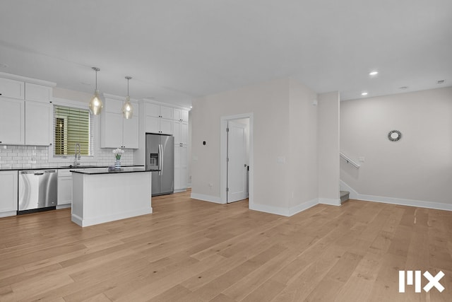627 Fairview Ave NE Unit 2, Grand Rapids, MI 49503 - kitchen featuring appliances with stainless steel finishes, a sink, backsplash, white cabinets, and recessed lighting