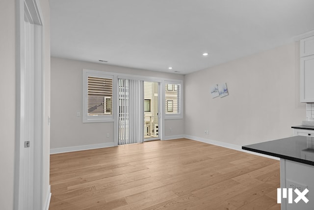 627 Fairview Ave NE Unit 2, Grand Rapids, MI 49503 - unfurnished living room with baseboards, light wood-style floors, and recessed lighting