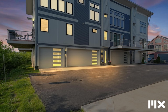 627 Fairview Ave NE Unit 2, Grand Rapids, MI 49503 - view of front facade with an attached garage, a balcony, board and batten siding, and driveway