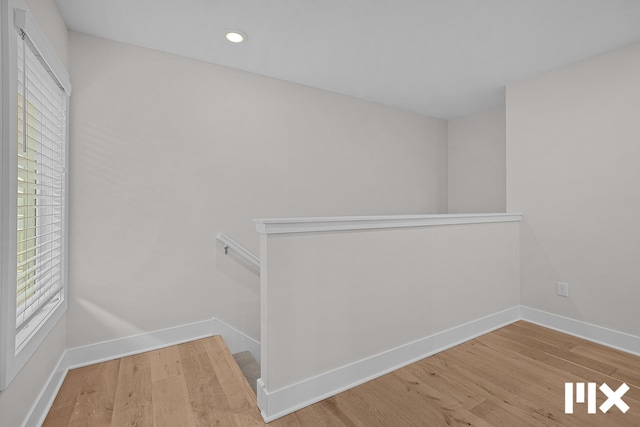 627 Fairview Ave NE Unit 2, Grand Rapids, MI 49503 - hallway with wood finished floors, baseboards, recessed lighting, and an upstairs landing
