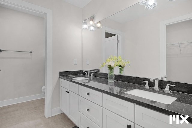 627 Fairview Ave NE Unit 2, Grand Rapids, MI 49503 - full bath with double vanity, toilet, baseboards, and a spacious closet