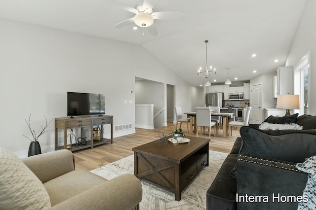 345 Hickory Valley Dr, Kalamazoo, MI 49009 - living room featuring a ceiling fan, vaulted ceiling, light wood-style flooring, recessed lighting, and a chandelier