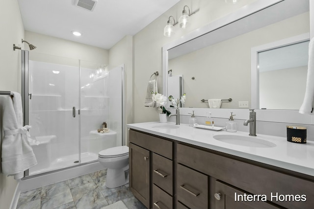 345 Hickory Valley Dr, Kalamazoo, MI 49009 - full bath with marble finish floors, double vanity, a shower stall, and toilet