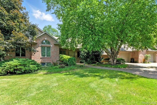 3680 Miller Rd, Ann Arbor, MI 48103 - view of front of house with brick siding, an attached garage, and a front yard