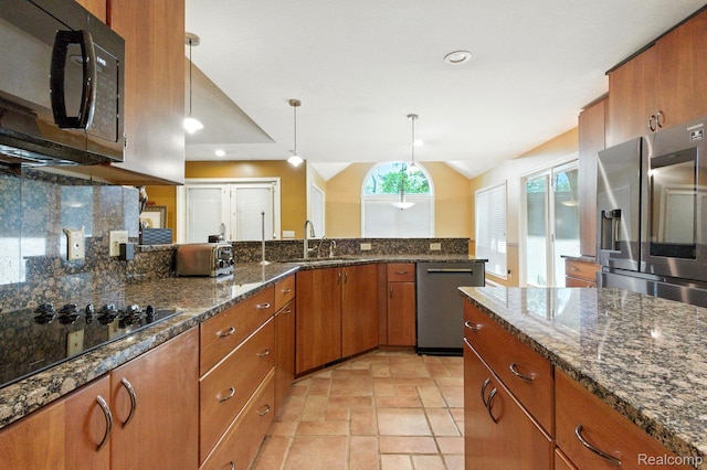 3680 Miller Rd, Ann Arbor, MI 48103 - kitchen featuring black appliances, brown cabinetry, lofted ceiling, backsplash, and decorative light fixtures