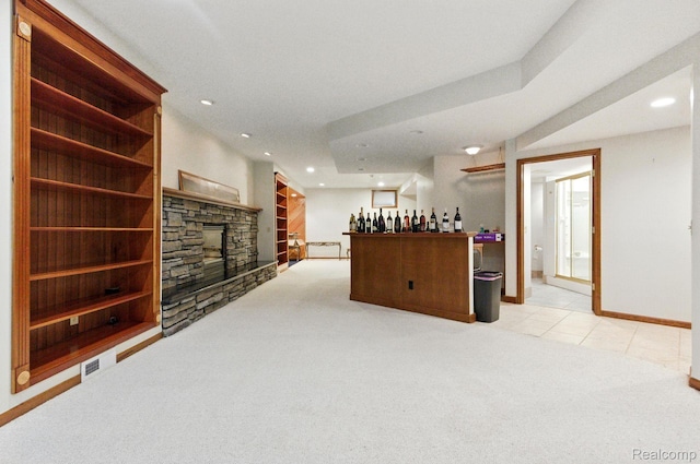 3680 Miller Rd, Ann Arbor, MI 48103 - living area featuring light carpet, a bar, a fireplace, recessed lighting, and light tile patterned floors
