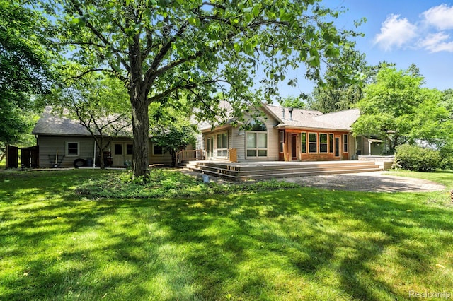 3680 Miller Rd, Ann Arbor, MI 48103 - rear view of house featuring a wooden deck and a lawn
