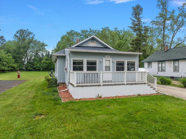4940 Pottawatamie Path, Watervliet, MI 49098 - view of front facade featuring a front yard, a chimney, and a wooden deck