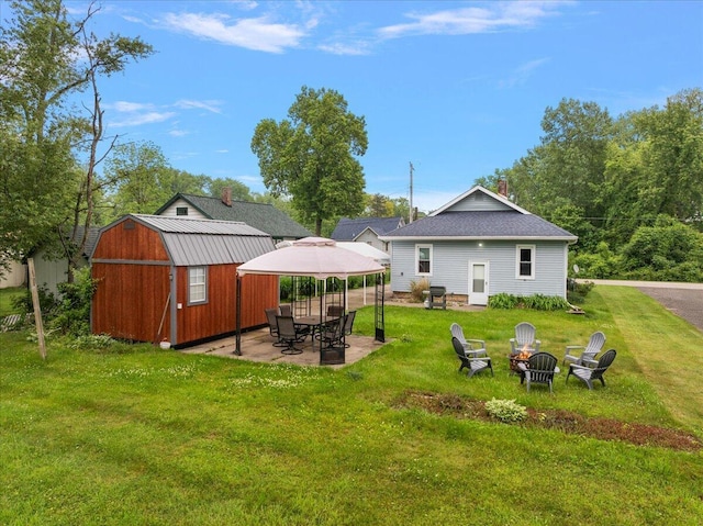 4940 Pottawatamie Path, Watervliet, MI 49098 - rear view of property with a fire pit, a yard, a gazebo, a patio, and a chimney