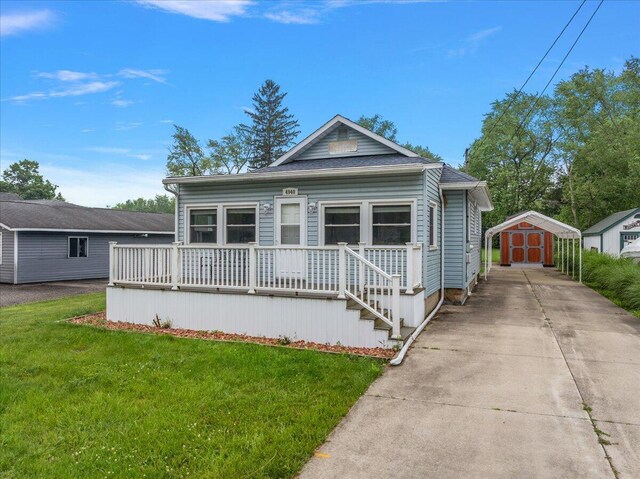 4940 Pottawatamie Path, Watervliet, MI 49098 - view of front of home with driveway, a front lawn, a detached carport, and covered porch