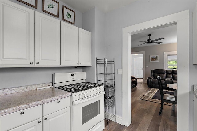 4940 Pottawatamie Path, Watervliet, MI 49098 - kitchen featuring gas range gas stove, dark wood finished floors, a ceiling fan, and white cabinets